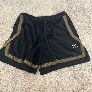 Black and gold Nike shorts